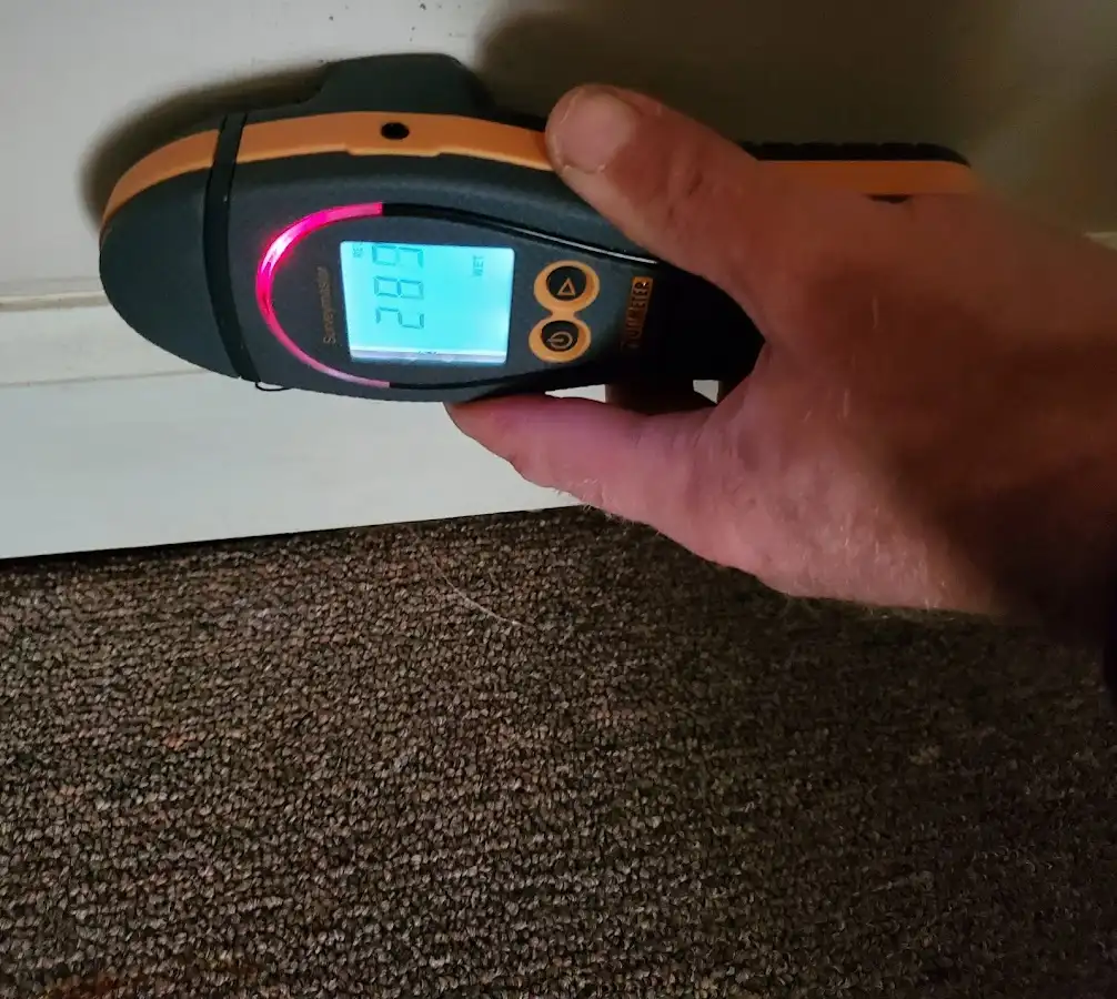 Moisture detection at baseboard during Storm Damage Restoration in Joshua